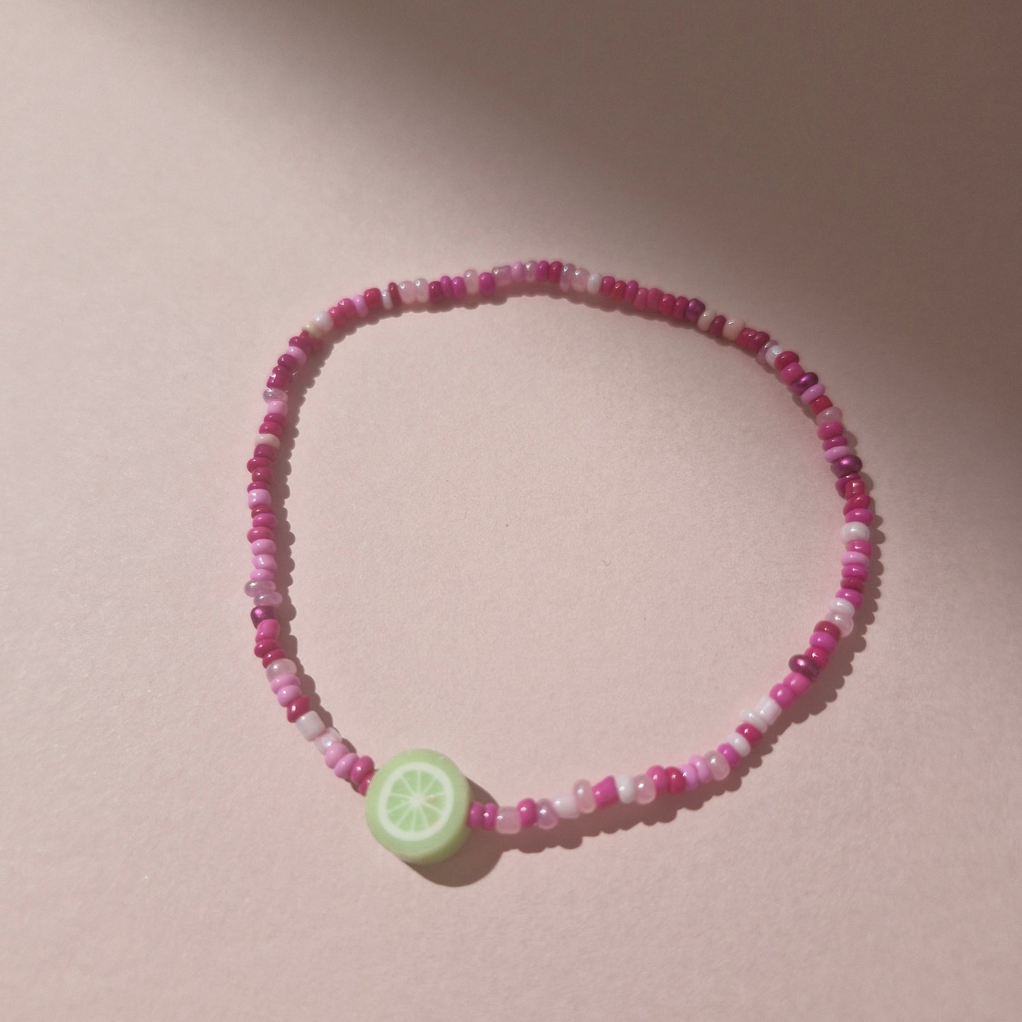 Pink Friendship Bracelet With A Lime Fruit