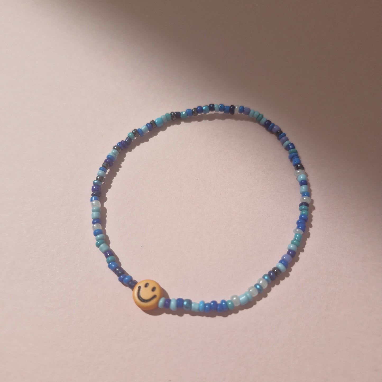 Blue Friendship Bracelet With A Orange Smiley Face