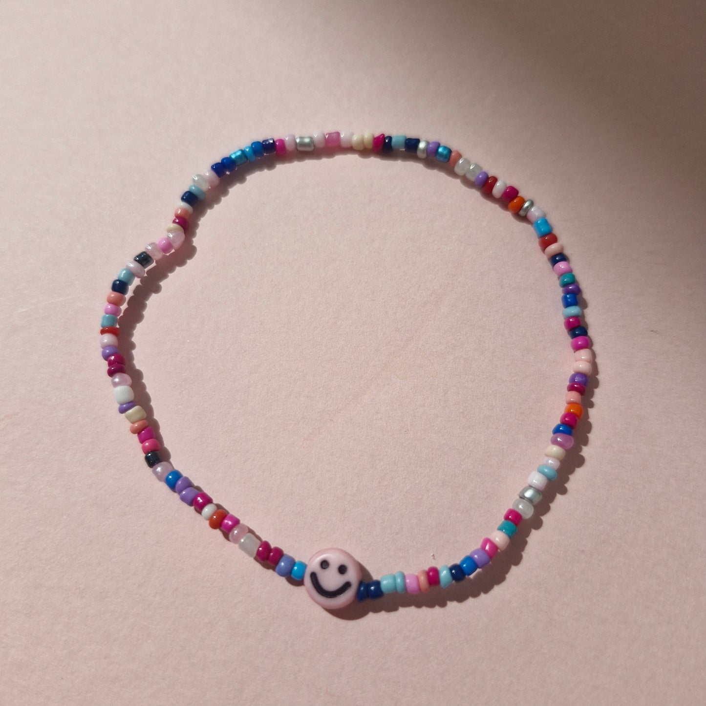 Multicoloured Friendship Bracelet With A Pink Smiley Face