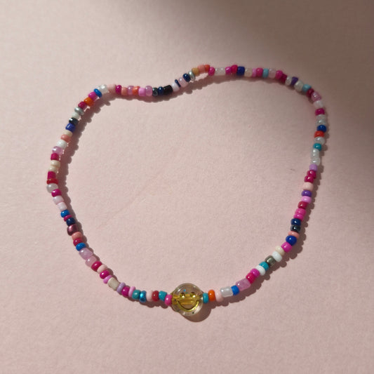 Multicoloured Friendship Bracelet With A Gold Glitter Smiley Face