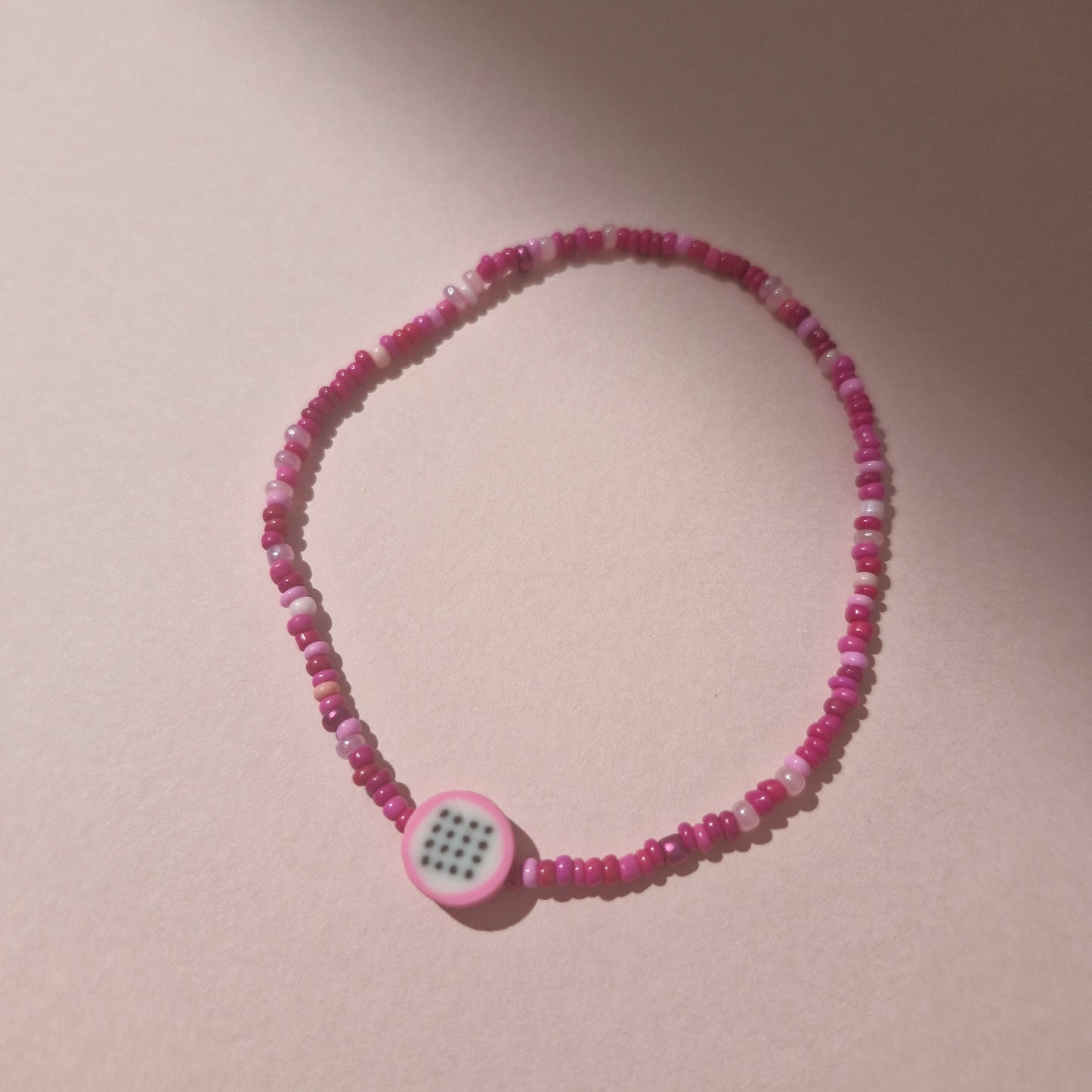 Pink Friendship Bracelet With A Dragon Fruit