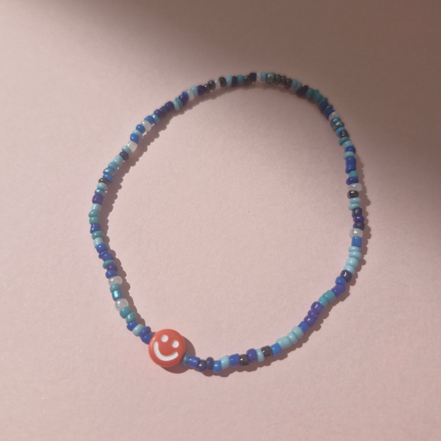 Blue Friendship Bracelet With A Orange Smiley Face