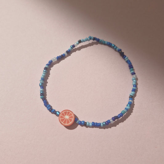 Blue Friendship Bracelet With A Pink Fruit