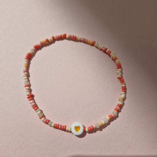 Coral/Peach Friendship Bracelet With An Orange Heart