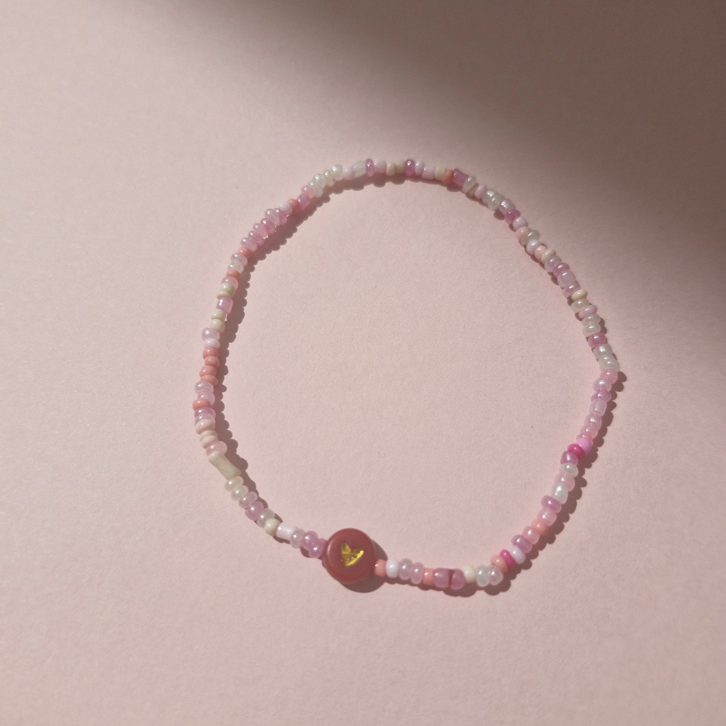 Light Pink Friendship Bracelet With A Red & Gold Heart