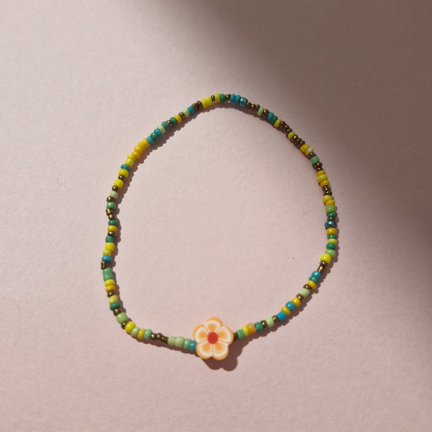 Green/Yellow Friendship Bracelet With An Orange Flower