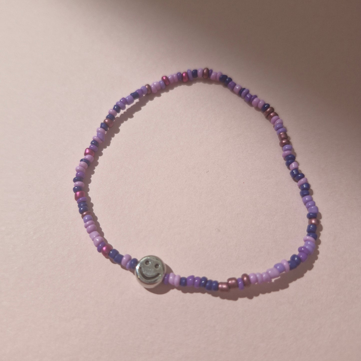 Purple Friendship Bracelet With A Silver Smiley Face