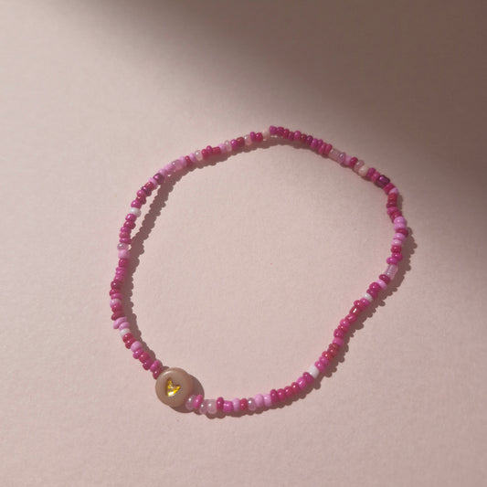 Pink Friendship Bracelet With A Brown Heart