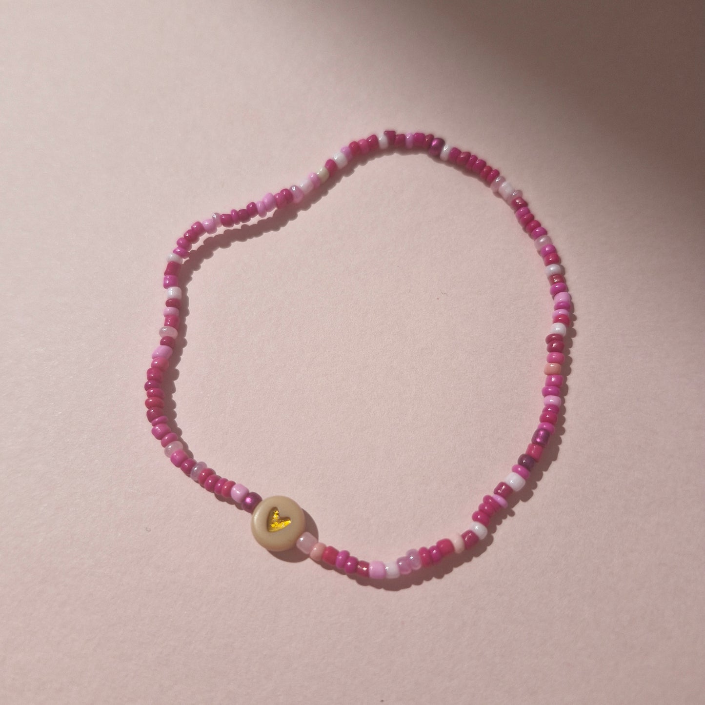 Pink Friendship Bracelet With A Beige Heart