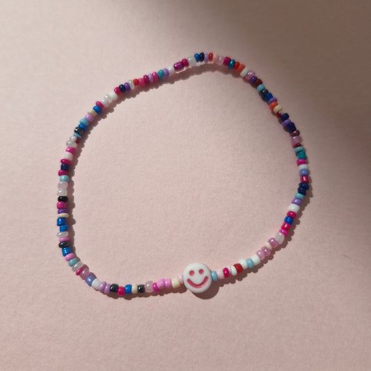 Multicoloured Friendship Bracelet With A Pink Smiley Face