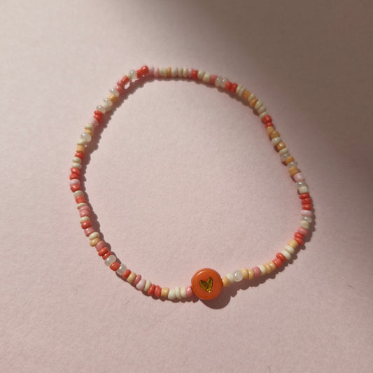 Coral/Peach Friendship Bracelet With A Coral & Gold Heart