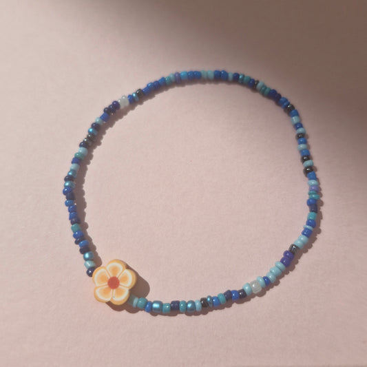 Blue Friendship Bracelet With An Orange Flower