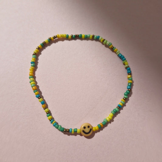 Green/Yellow Friendship Bracelet With An Orange Smiley Face