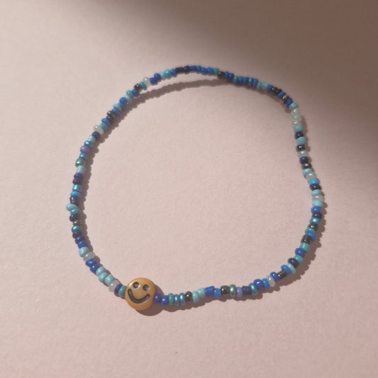 Blue Friendship Bracelet With A Orange Smiley Face