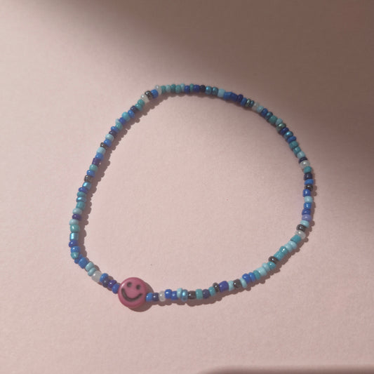 Blue Friendship Bracelet With A Hot Pink Smiley Face