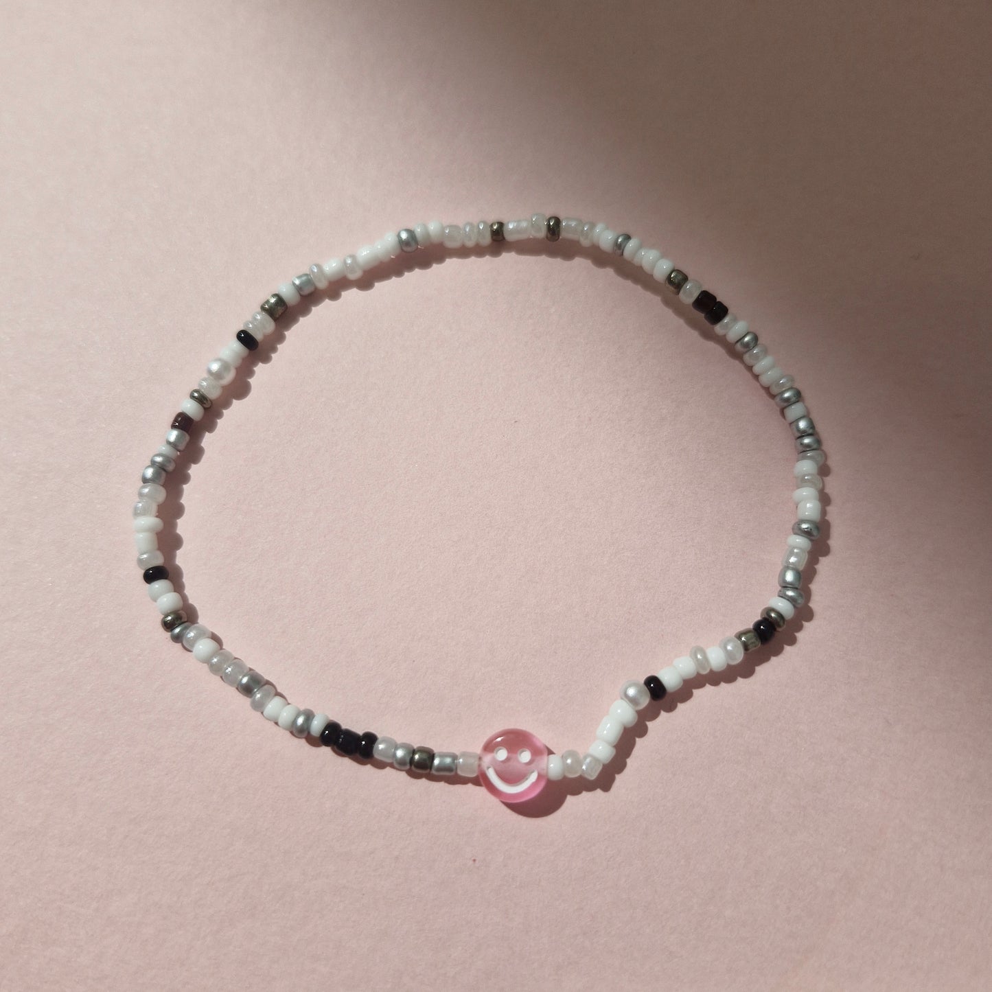 Black & White Friendship Bracelet With A Pink Smiley Face