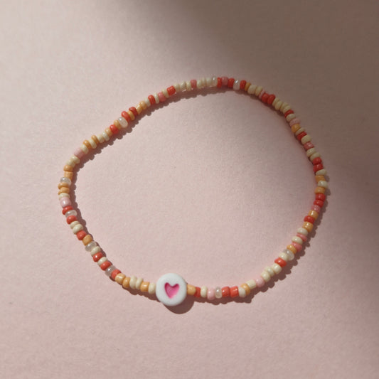 Coral/Peach Friendship Bracelet With A Pink Heart