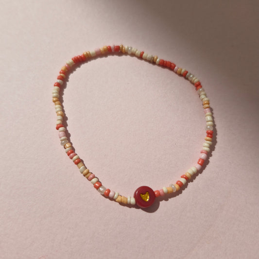 Coral/Peach Friendship Bracelet With A Red & Gold Heart