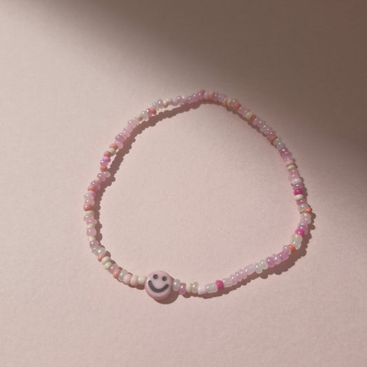 Light Pink Friendship Bracelet With A Light Pink Smiley Face