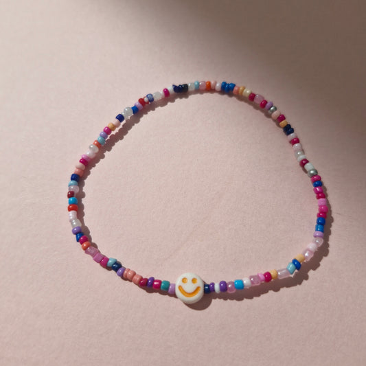 Multicoloured Friendship Bracelet With An Orange Smiley Face